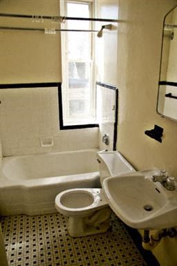 a bathroom with a toilet and a sink and a bath tub