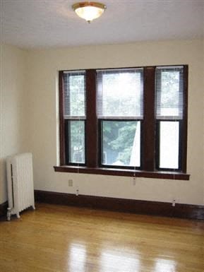 a living room with a large window and a wood floor