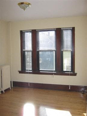 a living room with a large window and a wooden floor