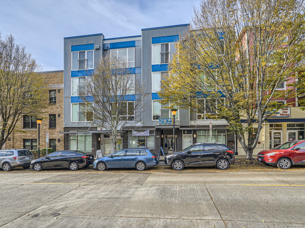 Exterior street view of the modern 509 1st apartment building in Seattle.