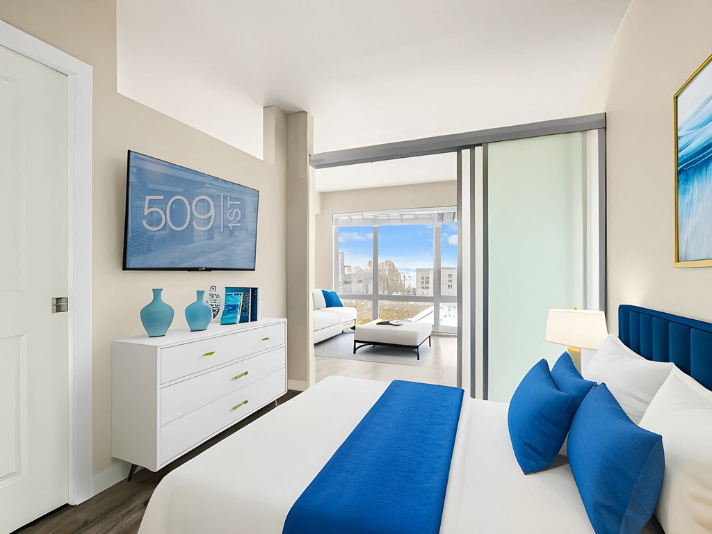 a bedroom with a large bed and a sliding glass door