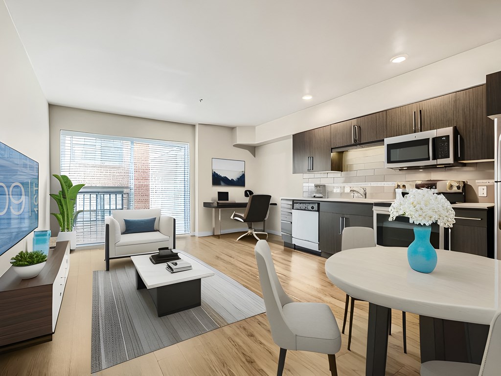 a living room and kitchen with a table and chairs