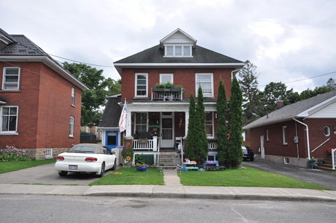 a house with a white car parked in front of it