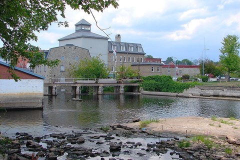 a bridge over a river with a building in the background