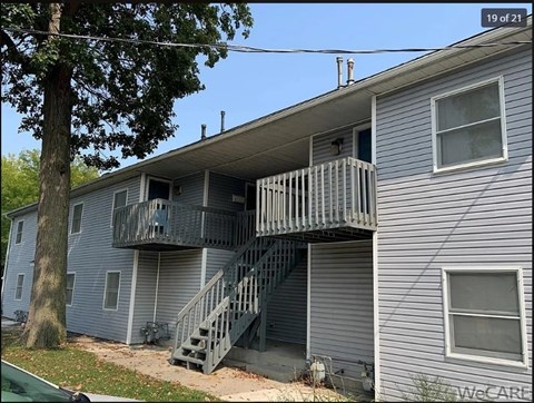 A house with a balcony and stairs leading to it.
