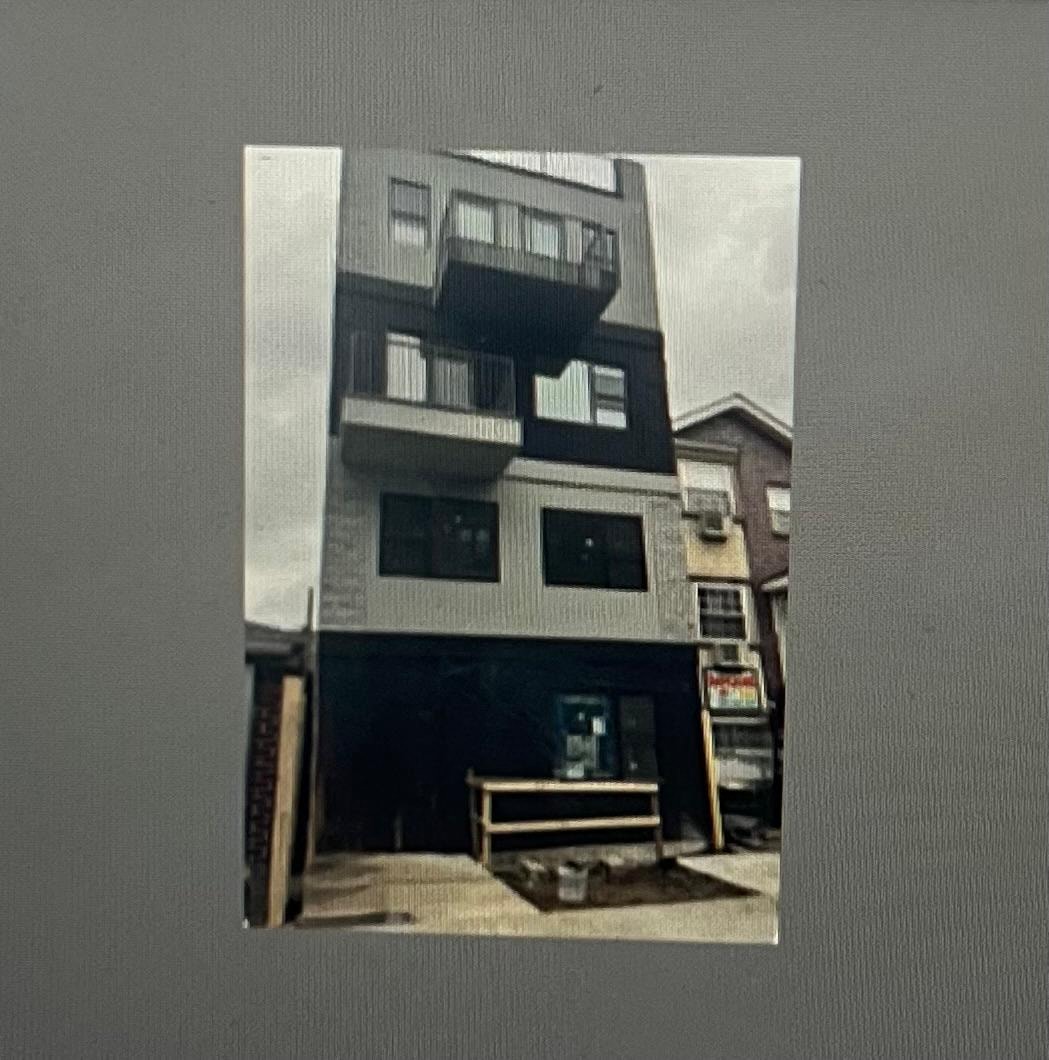 a picture of a building with a bench in front of it