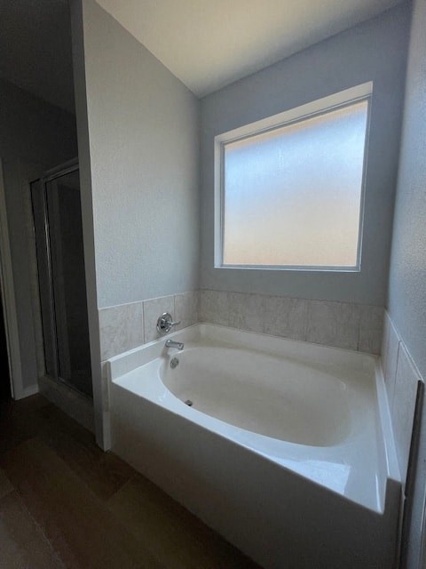a bathroom with a bath tub and a window