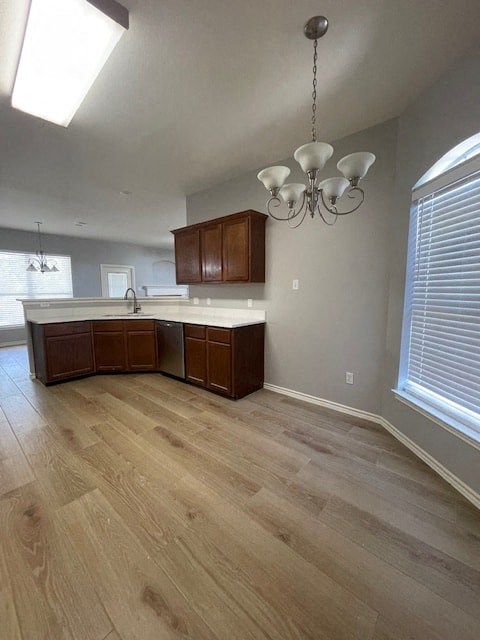 an empty kitchen with wooden floors and a chandelier