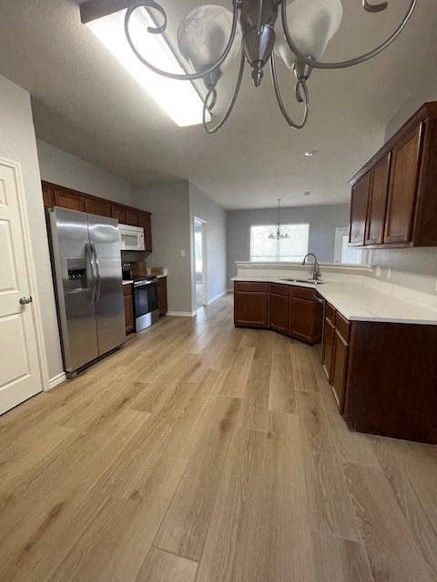 a kitchen with wooden floors and a stainless steel refrigerator
