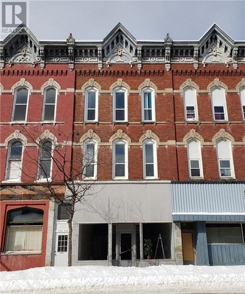 a red brick building with snow in front of it