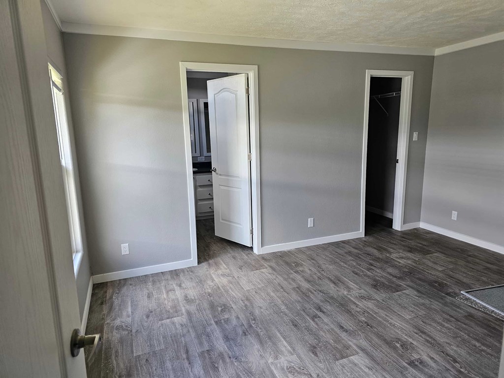A room with a grey floor and a white door.