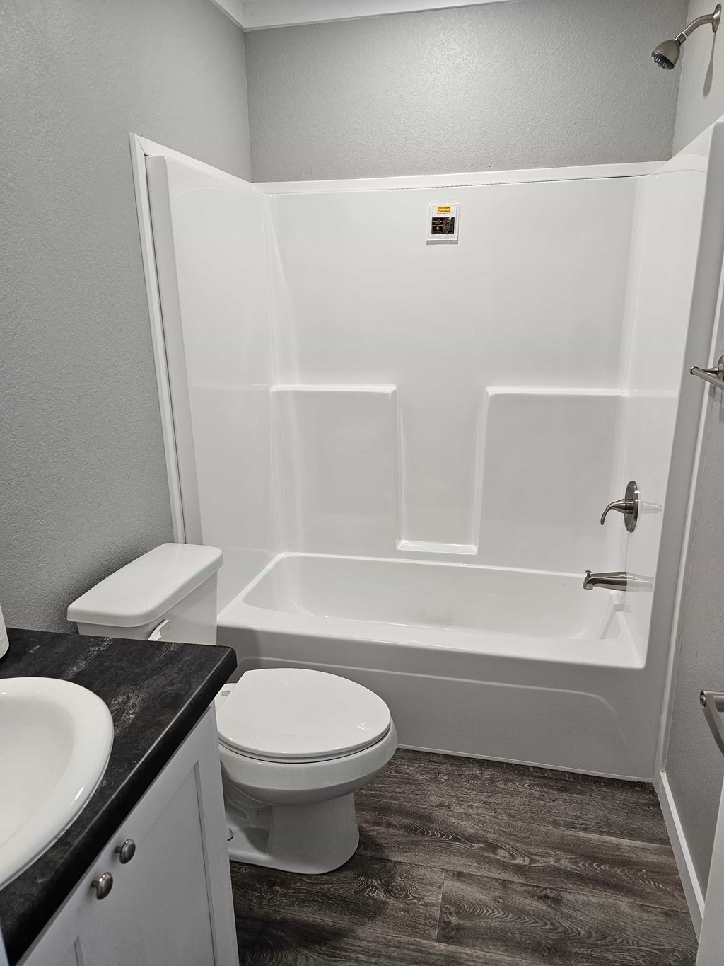 A white toilet and sink in a small bathroom.