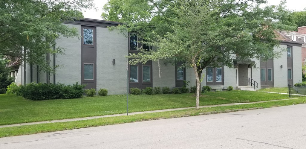 an apartment building with a street in front of it