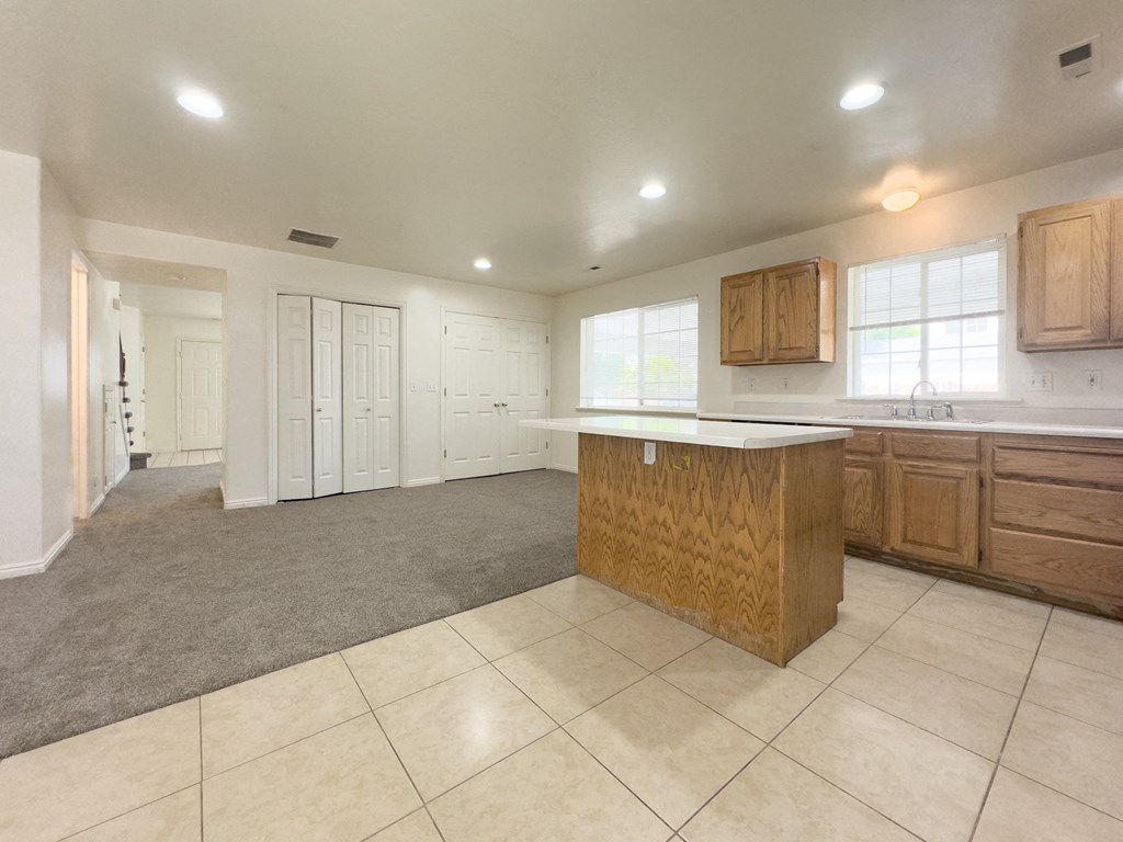 A kitchen with a wooden island in the middle of the room.