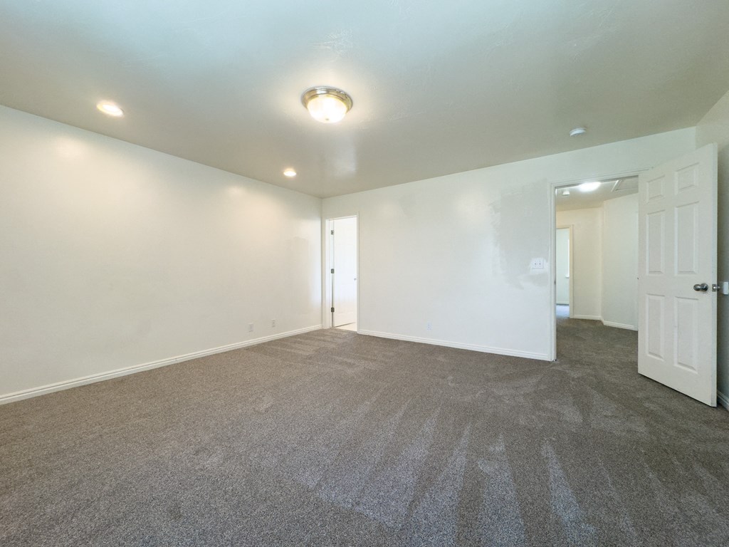 A room with carpeted floor and white walls.