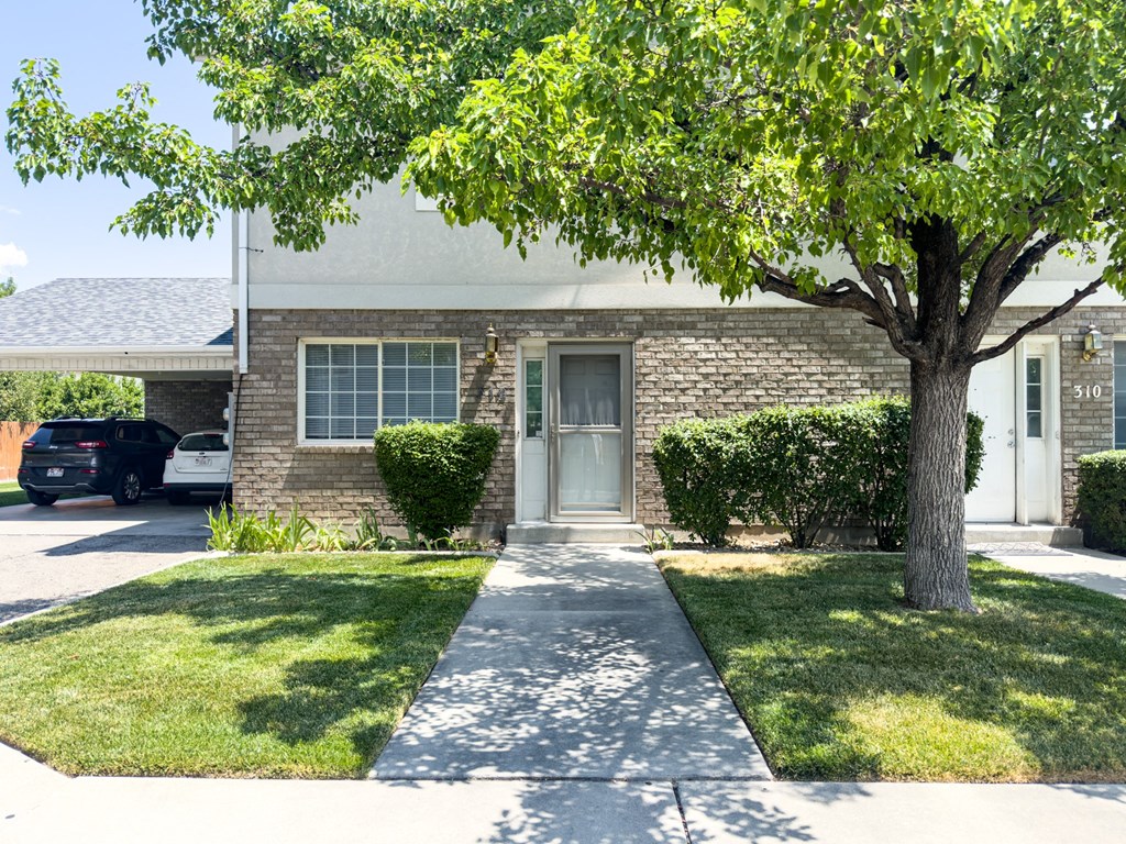 A house with a tree in front of it.