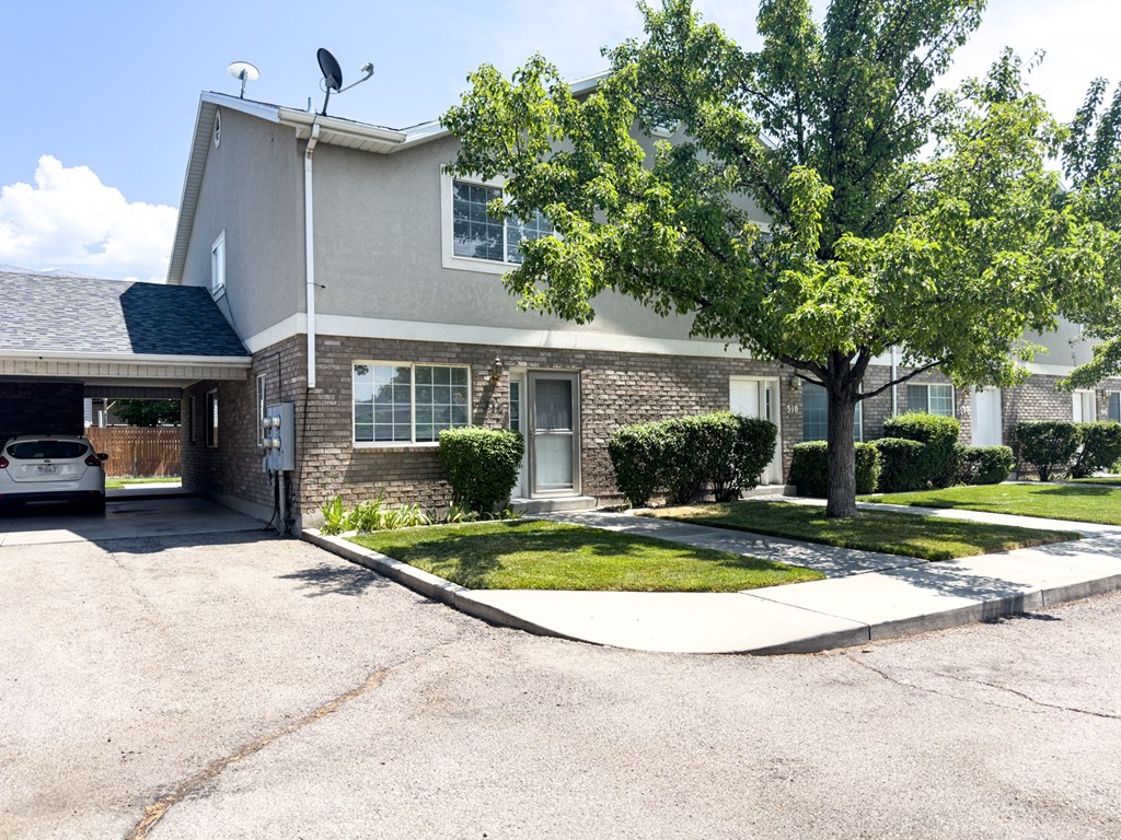 A house with a tree in front of it.