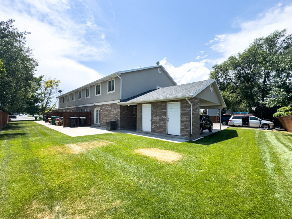 A house with a grey roof and a white garage door.