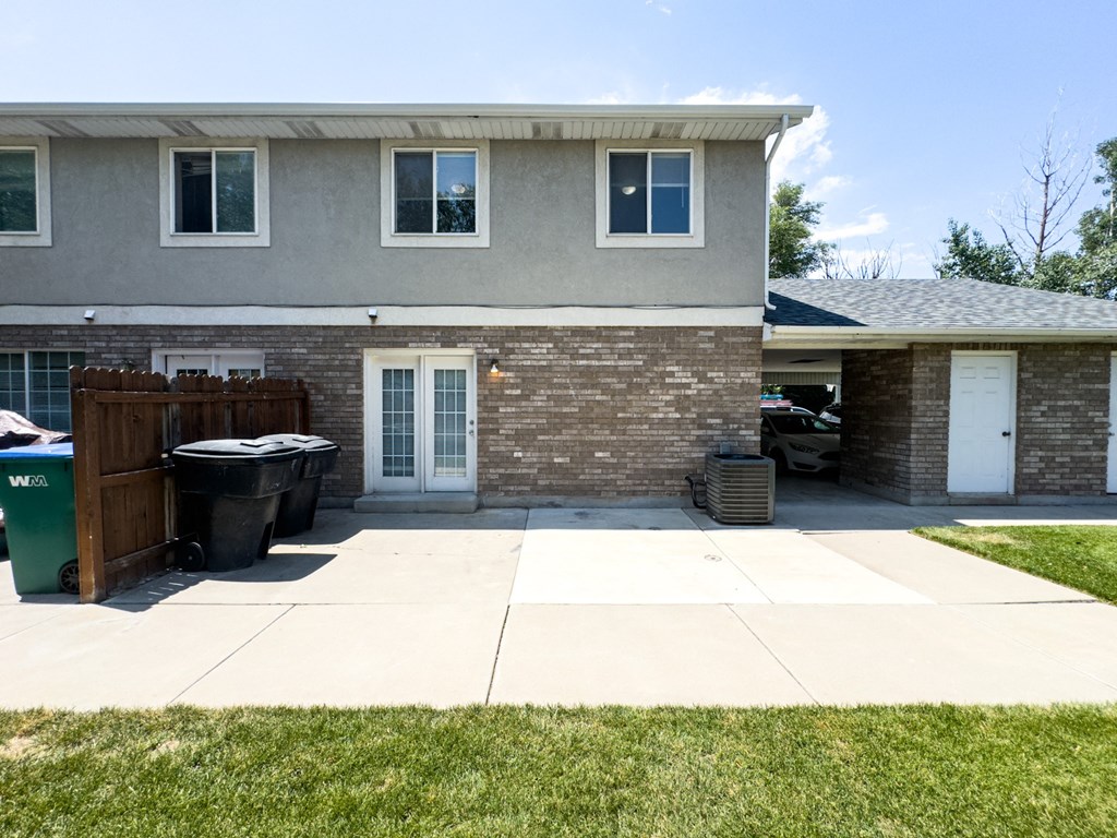 A house with a grey roof and a white door.