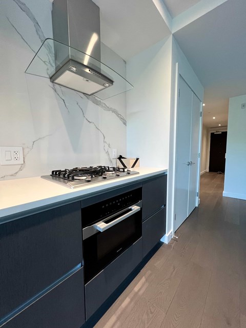 a black and white kitchen with a stove and oven
