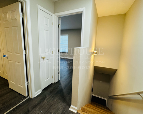 a bedroom with a closet and a door leading into a hallway