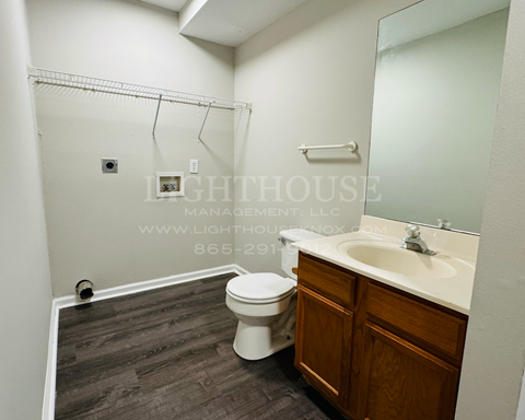 a bathroom with a toilet and a sink and a mirror