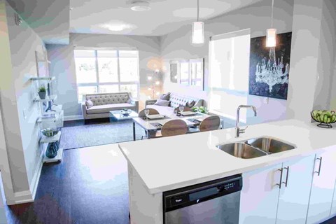 A modern kitchen with a large island and a dining area.