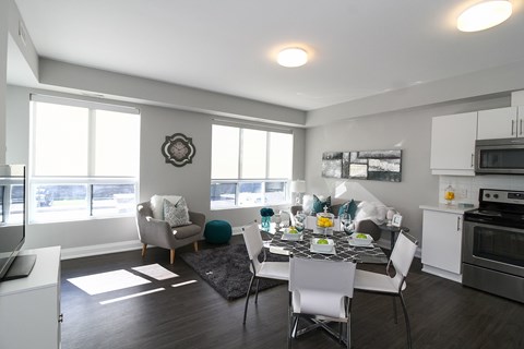 A modern kitchen with a dining table set for four.