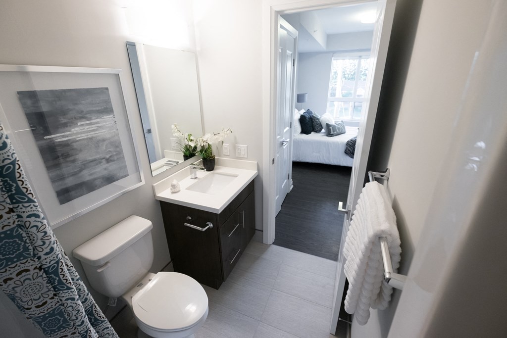 a small bathroom with a toilet and a sink and a mirror