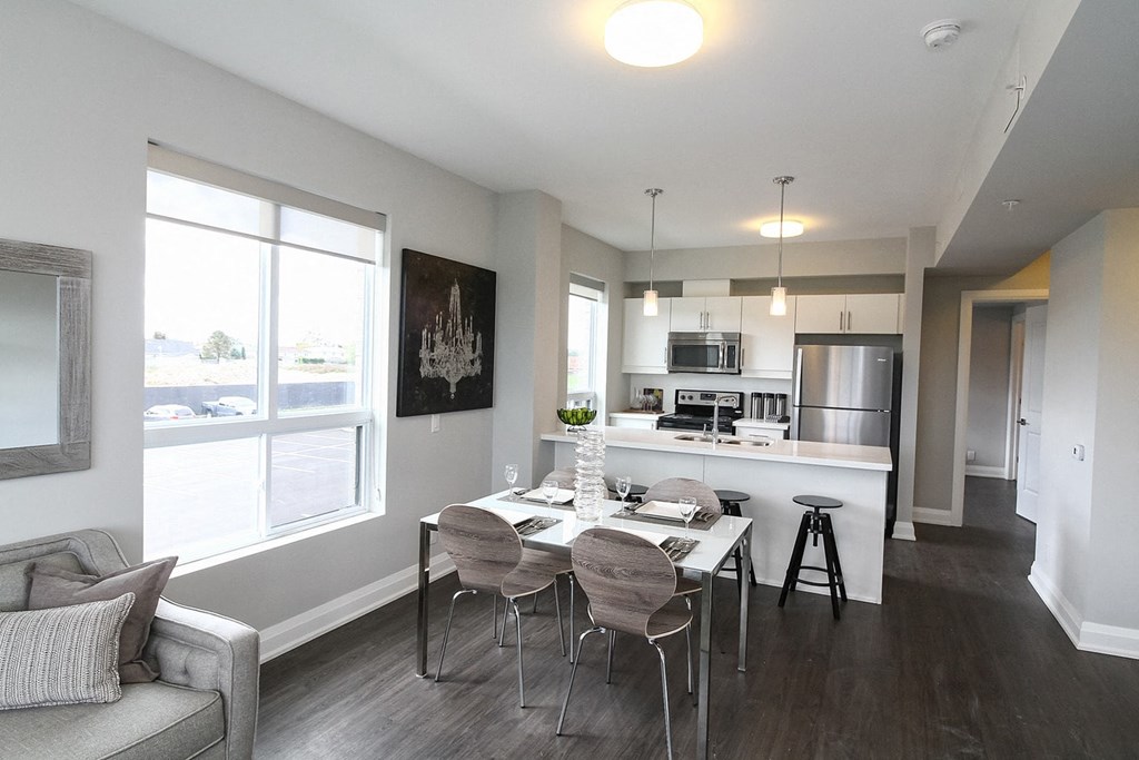 a kitchen and dining room with a table and chairs