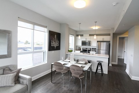 a kitchen and dining room with a table and chairs