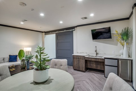 A modern kitchen with a grey table and chairs.