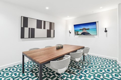 A modern dining room with a wooden table and chairs.