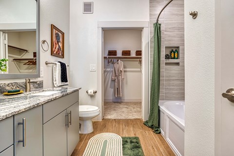 a bathroom with a shower and a toilet and a sink