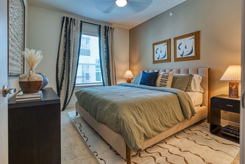 a bedroom with a bed and a window