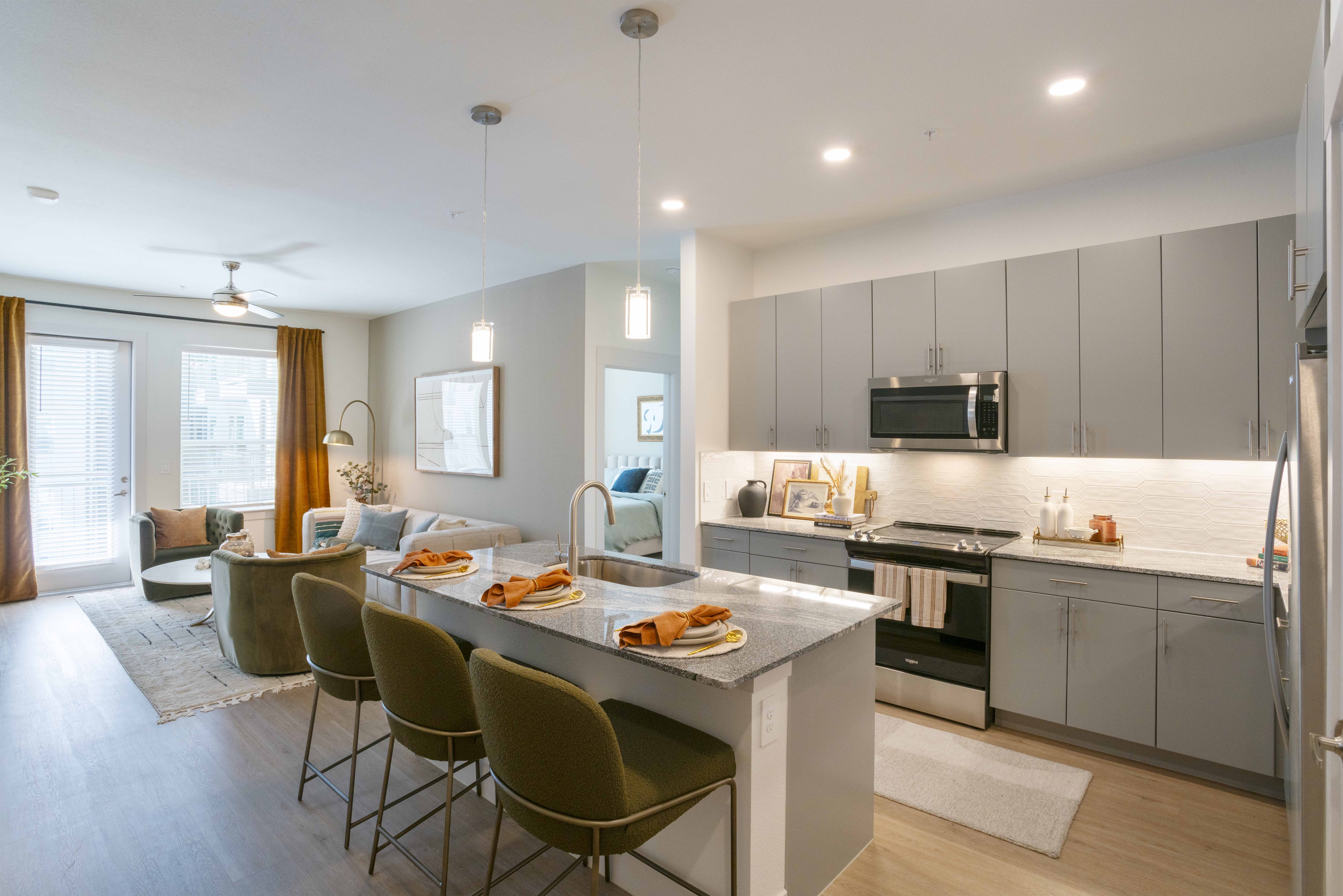 A modern kitchen with a dining table and chairs.