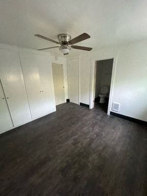 a living room with a ceiling fan and wood floors