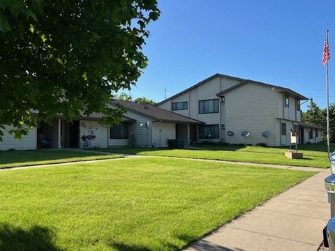 a white house with a lawn in front of it
