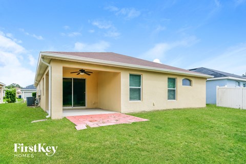 the front of a house with a yard and grass