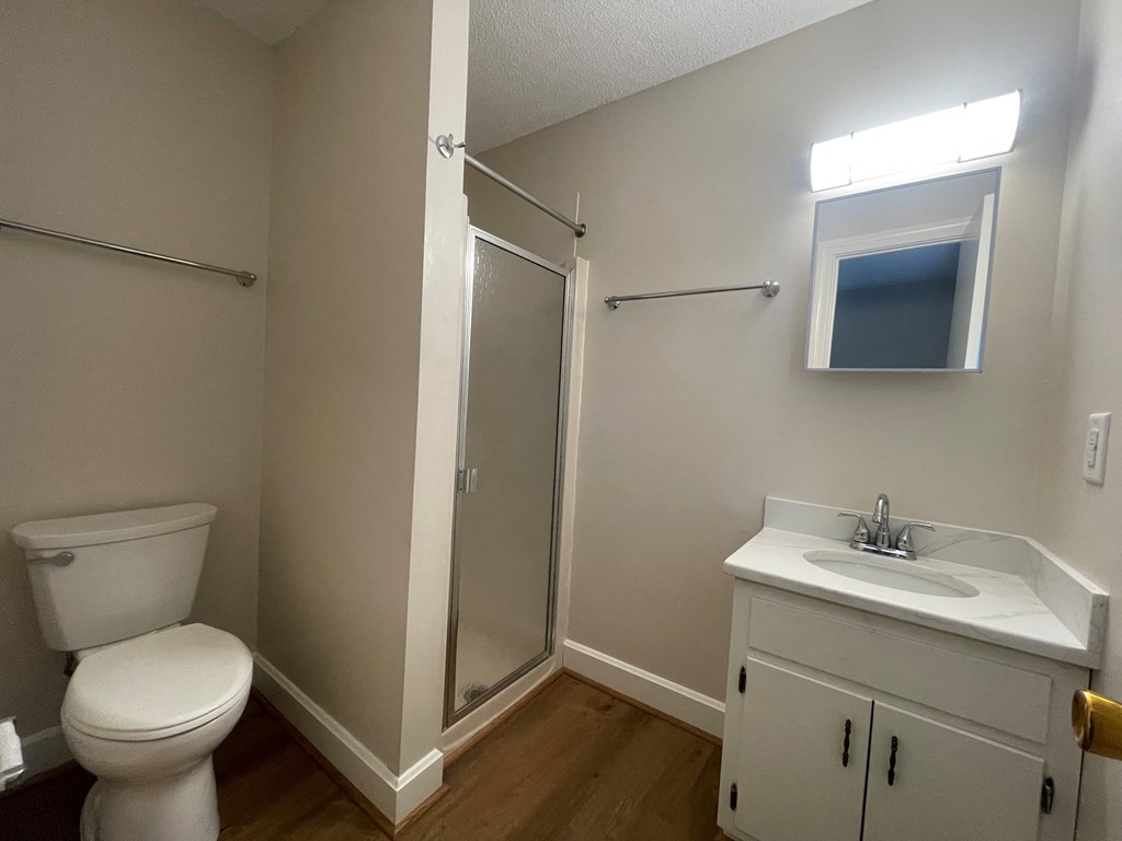 a bathroom with a toilet sink and shower