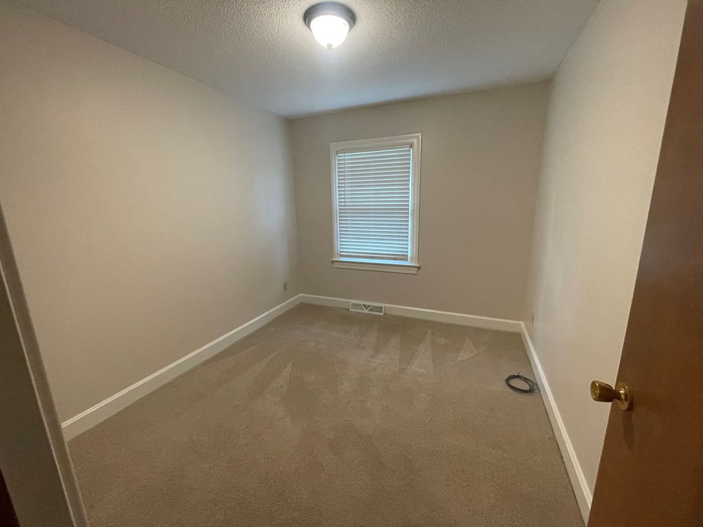 a empty room with a window and a door