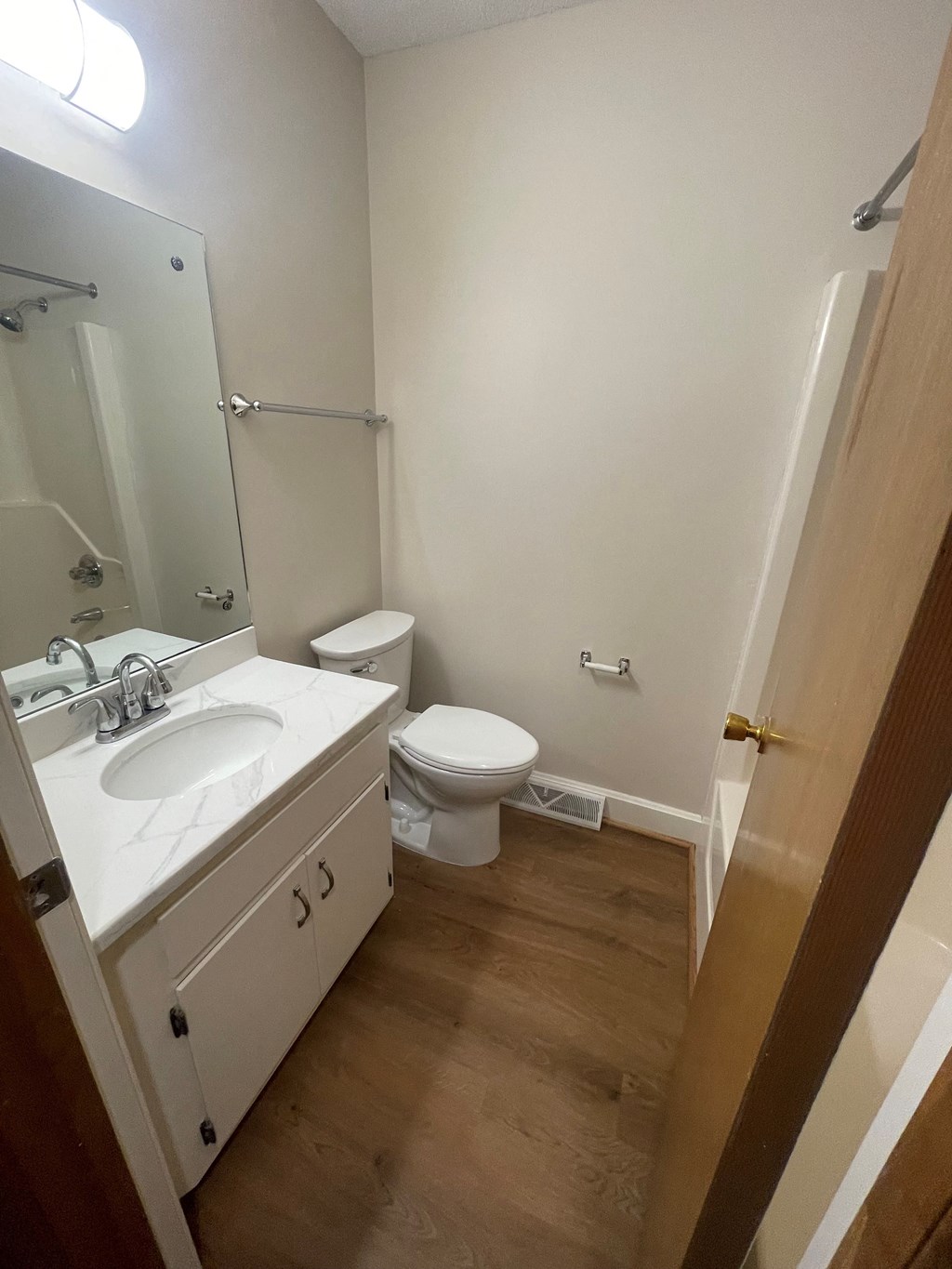 a small bathroom with a sink toilet and mirror