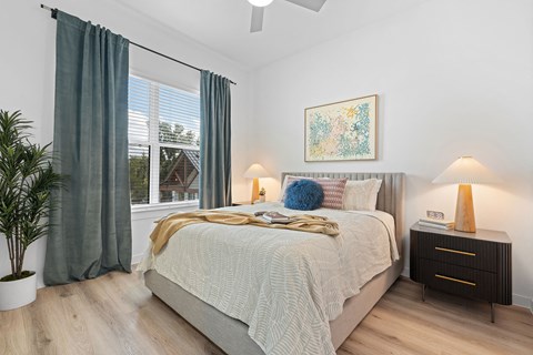 a bedroom with a bed and a large window