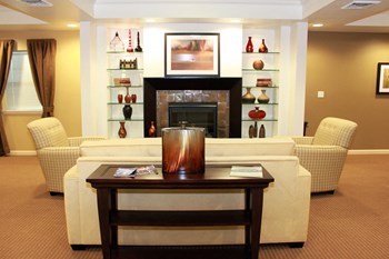 Resident Clubhouse, large seating area, two sofa chairs, fireplace - Photo Gallery 6