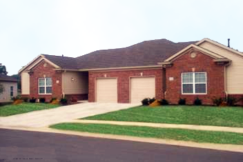 Exterior of Village at Wayne Trace, Brick apartment home, two attached garages, green landscaping