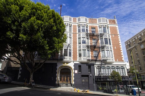 A large building with a black gate in front.