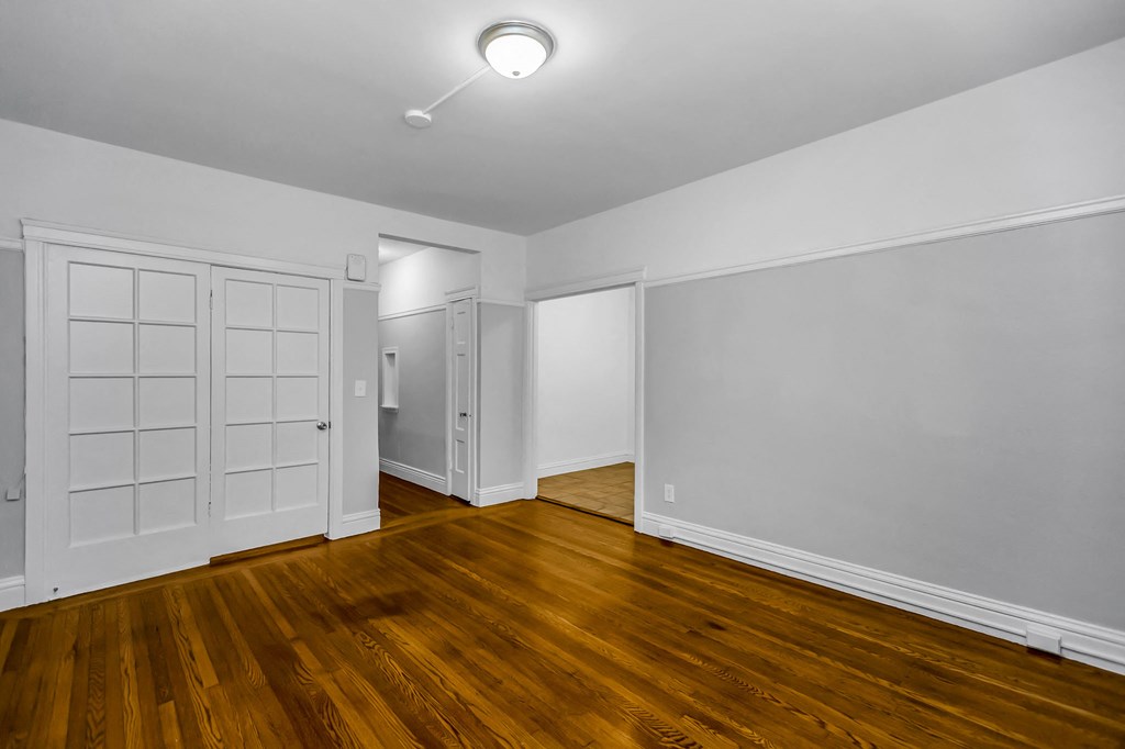 A room with wooden floors and white walls.