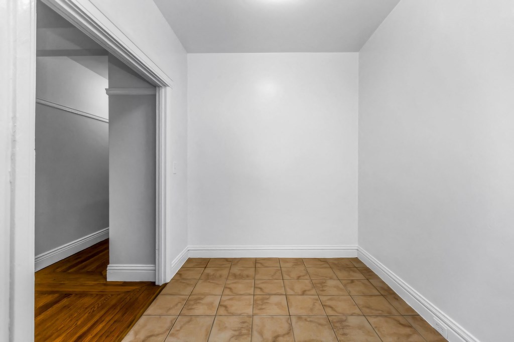 A room with white walls and a wooden floor.