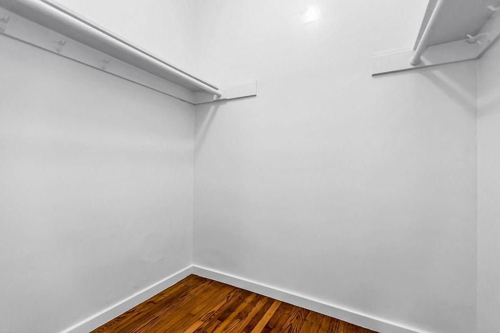 A room with white walls and wooden flooring.