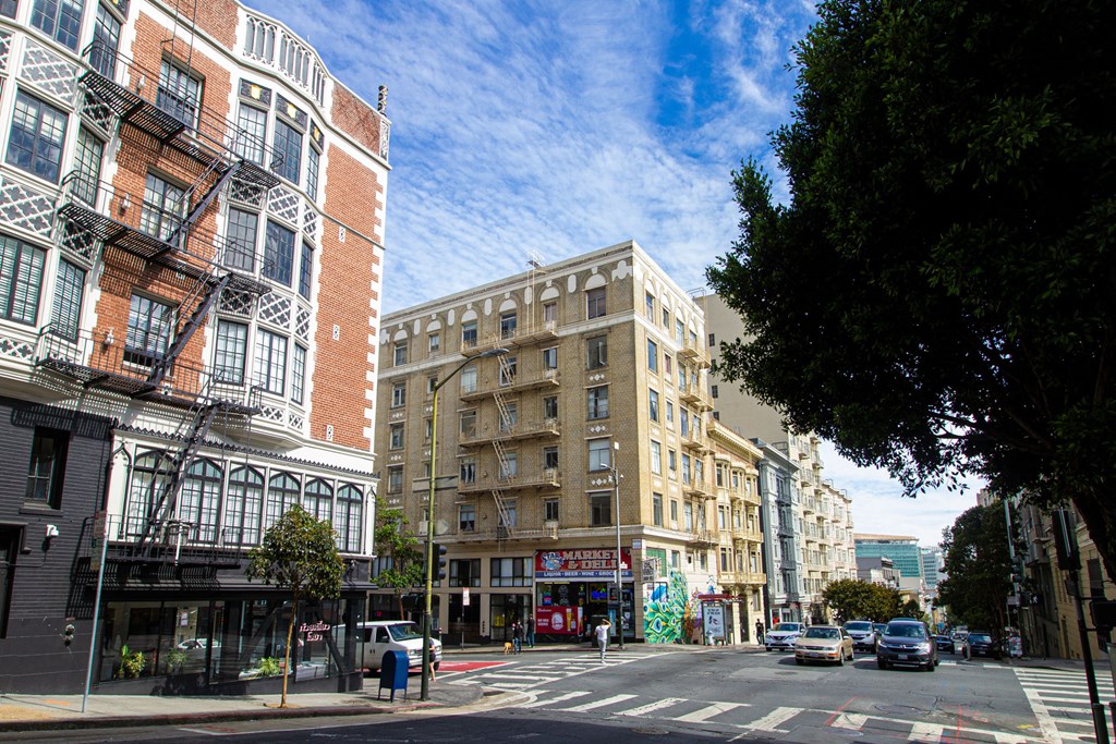 A city street with cars and buildings.